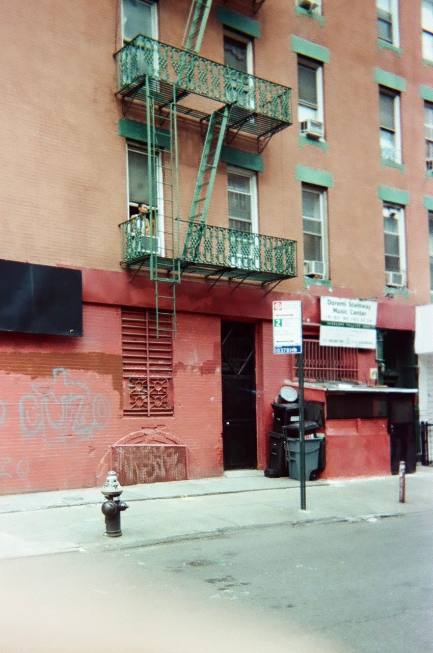 chinatown. man in window and fire escapes