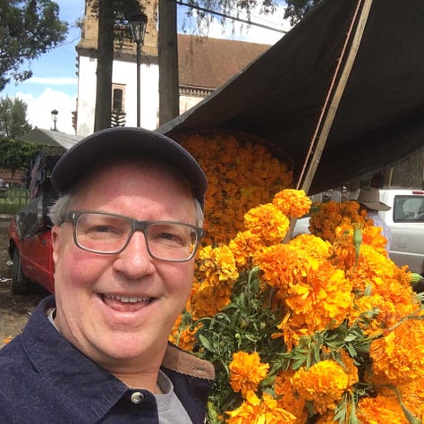 ofrendas decorated with candles, and colorful marigolds
