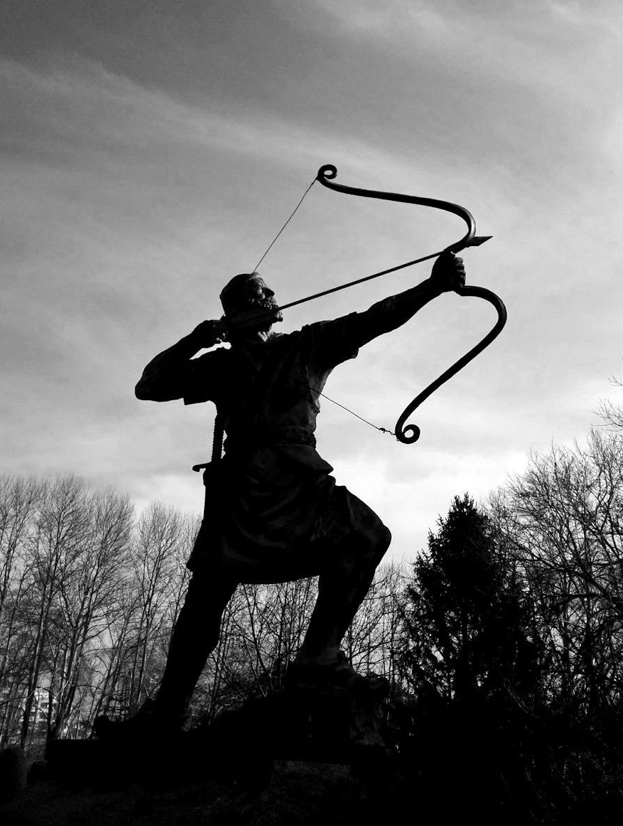 man holding archer statue man holding archer statue