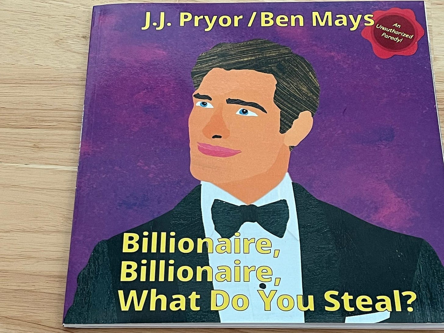 Billionaire Billionaire What Do You Steal book cover on a desk, more zoomed in