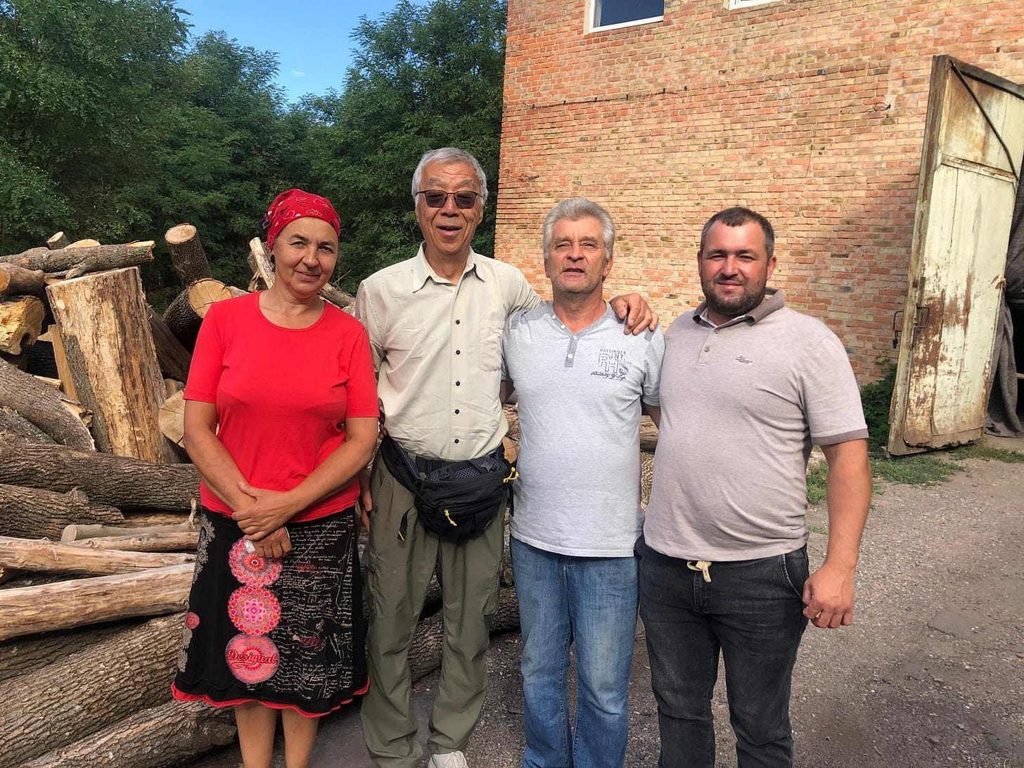 A group of people standing in front of a brick building

AI-generated content may be incorrect.