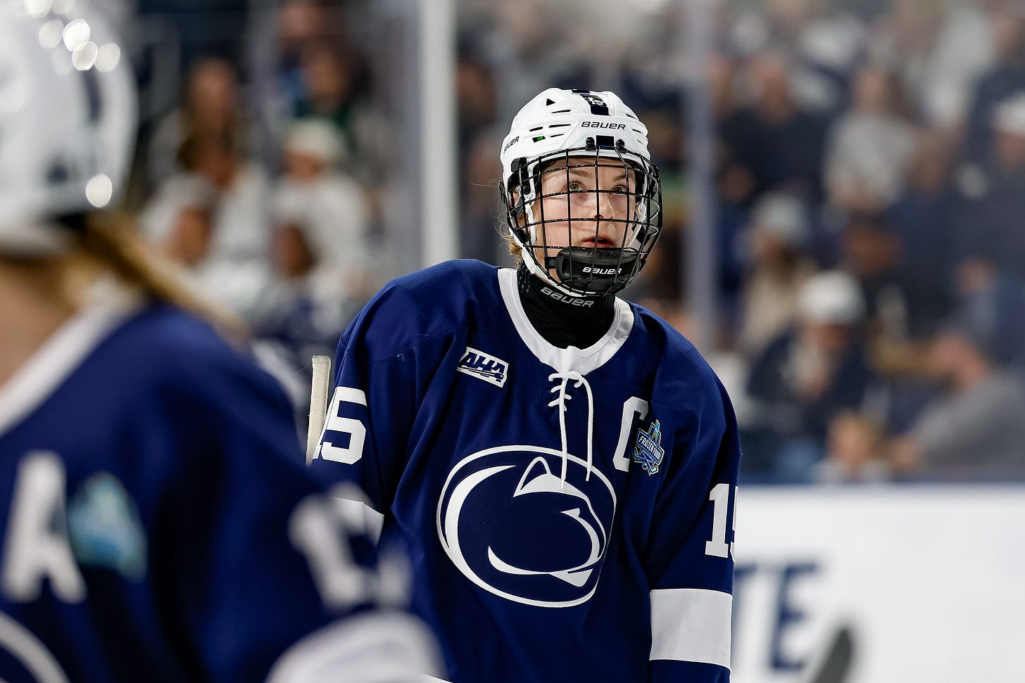 Tessa Janecke on the ice looks up Tessa Janecke on the ice looks up