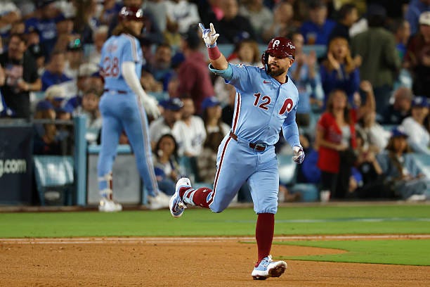 Kyle Schwarber of the Philadelphia Phillies reacts after hitting a solo home run against the Los Angeles Dodgers during the fourth inning in game...