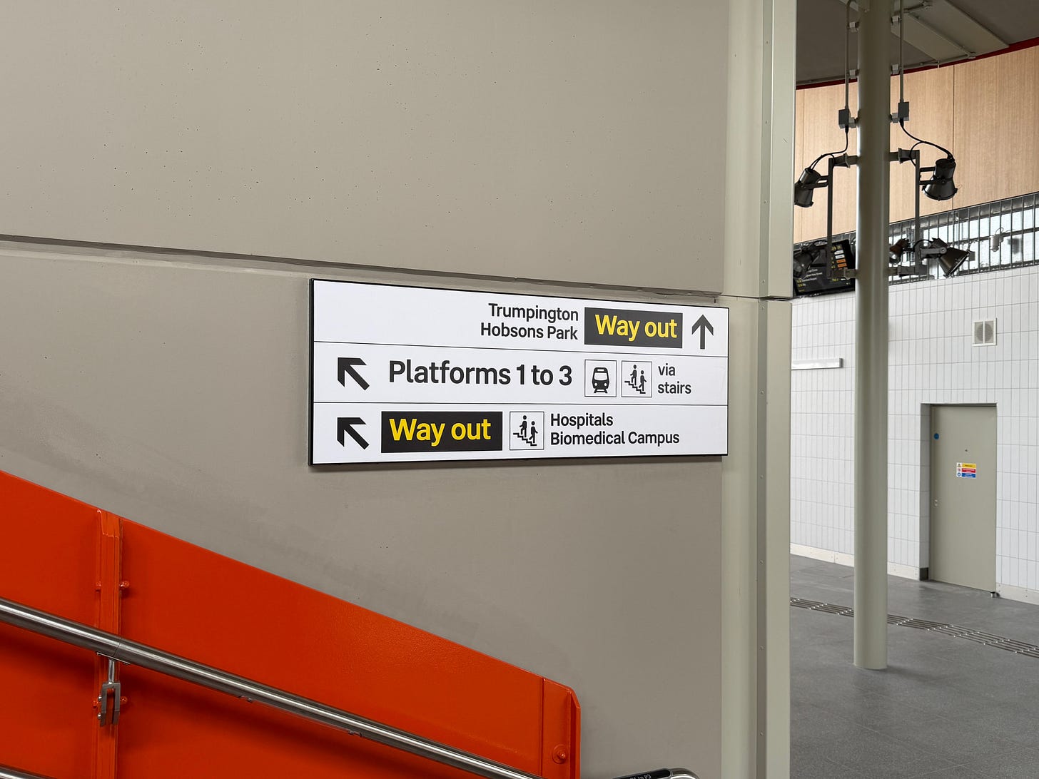 Photo of wayfinding signage at bottom of stairs on eastern side.