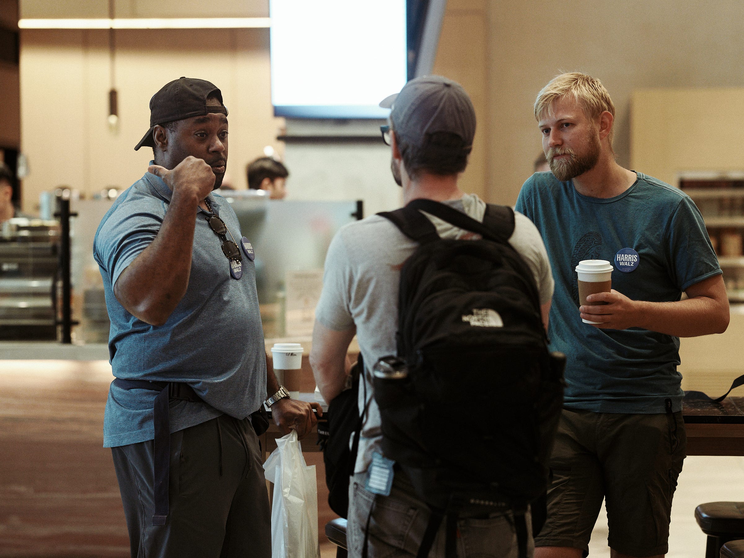 Volunteers talking in the hotel lobby while having coffee before their canvassing shift starts in Phoenix, AZ photographed by LA photographer Afonso Salcedo Volunteers talking in the hotel lobby while having coffee before their canvassing shift starts in Phoenix, AZ photographed by LA photographer Afonso Salcedo