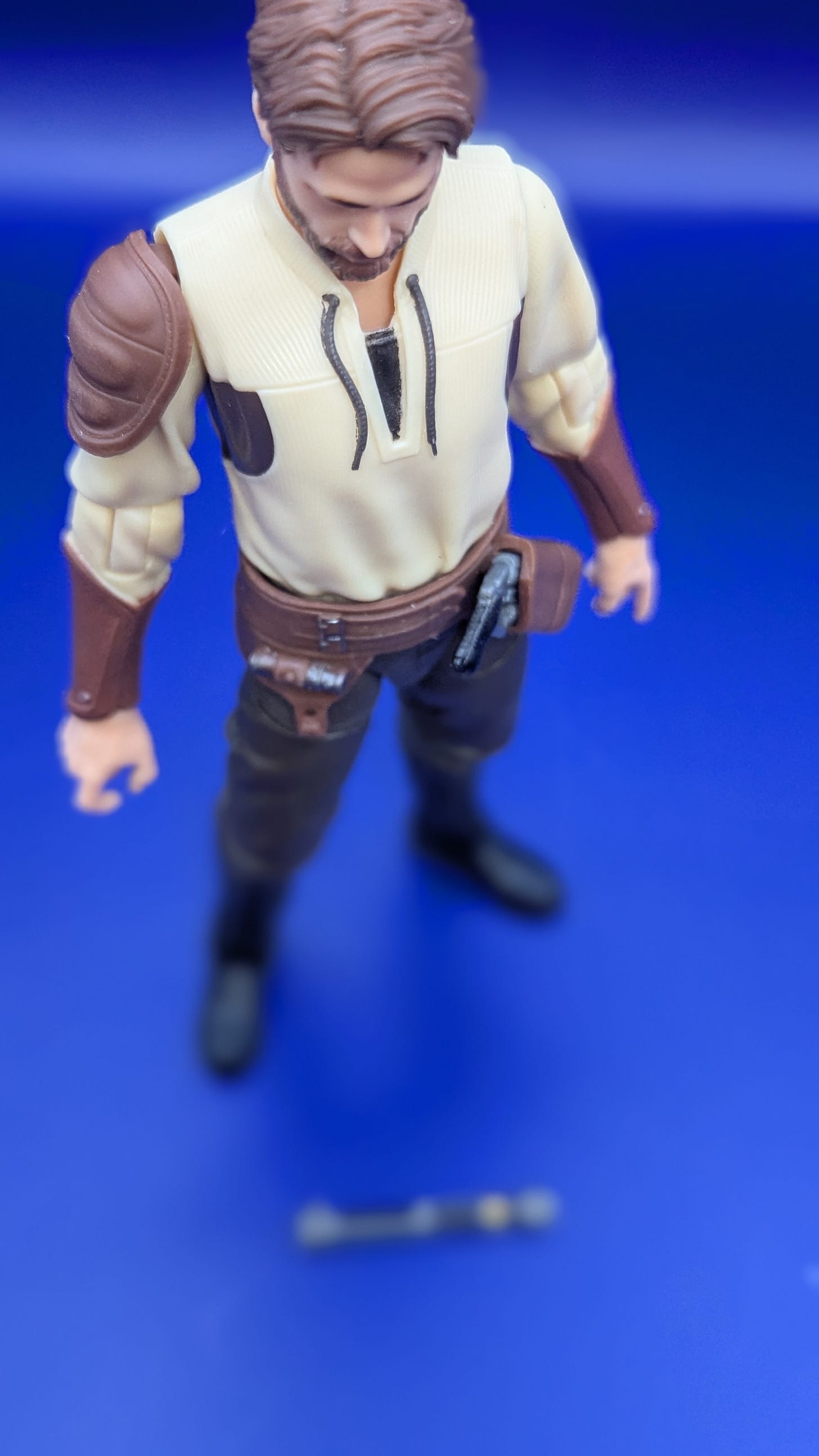 Star Wars: The Black Series Kyle Katarn looking down at his lightsaber hilt, which has landed on the ground, on a blue background Star Wars: The Black Series Kyle Katarn looking down at his lightsaber hilt, which has landed on the ground, on a blue background