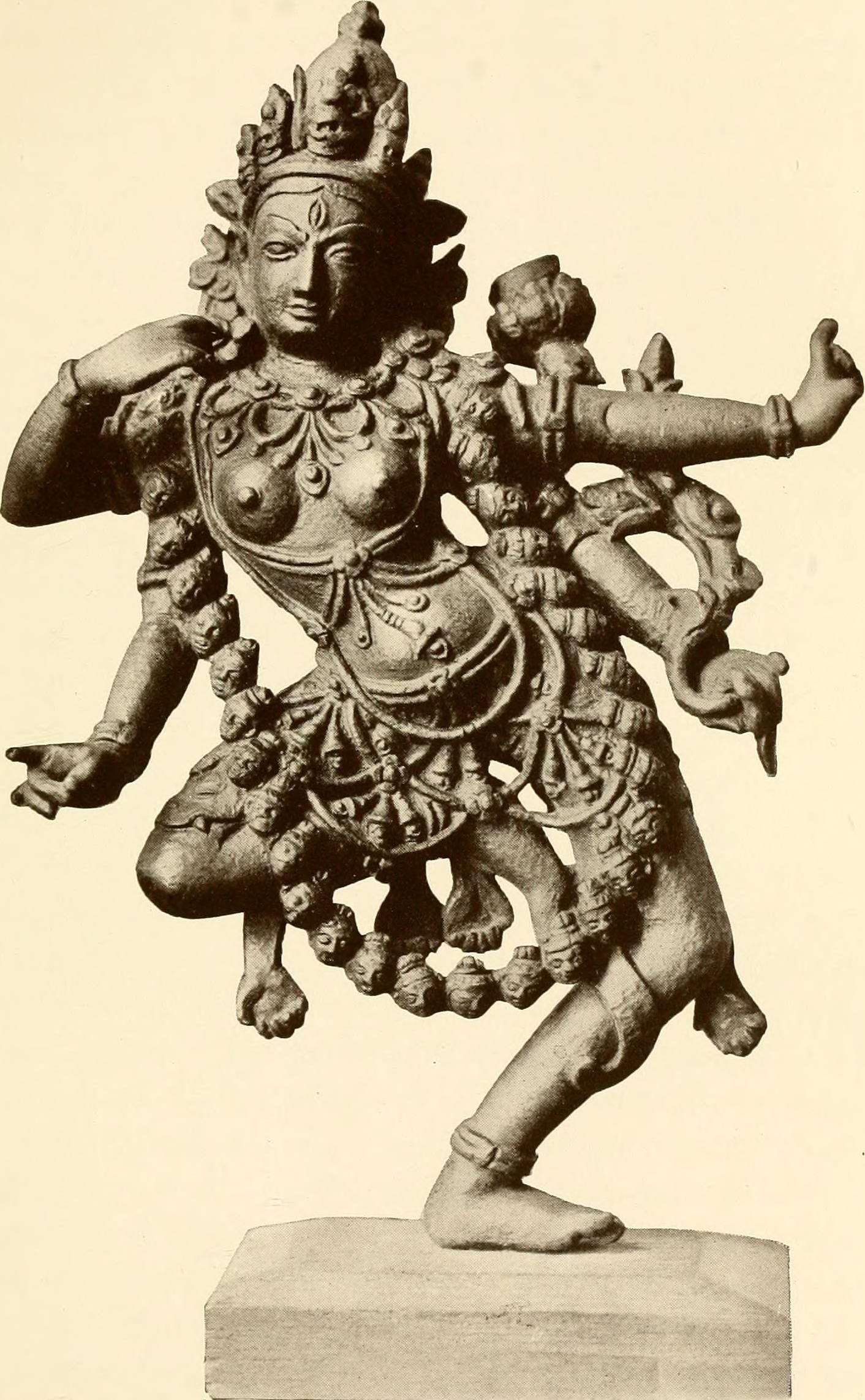 Photograph of a sculpture of the wrathful goddess Kurukulla. She is dancing, has four arms, and is wearing a necklace of skulls. Photograph of a sculpture of the wrathful goddess Kurukulla. She is dancing, has four arms, and is wearing a necklace of skulls.