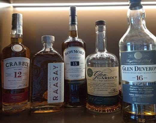 A group of bottles of alcohol

AI-generated content may be incorrect.