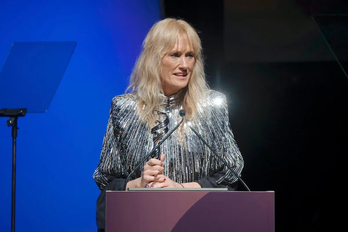 Shawna Trpcic is seen onstage accepting an award.