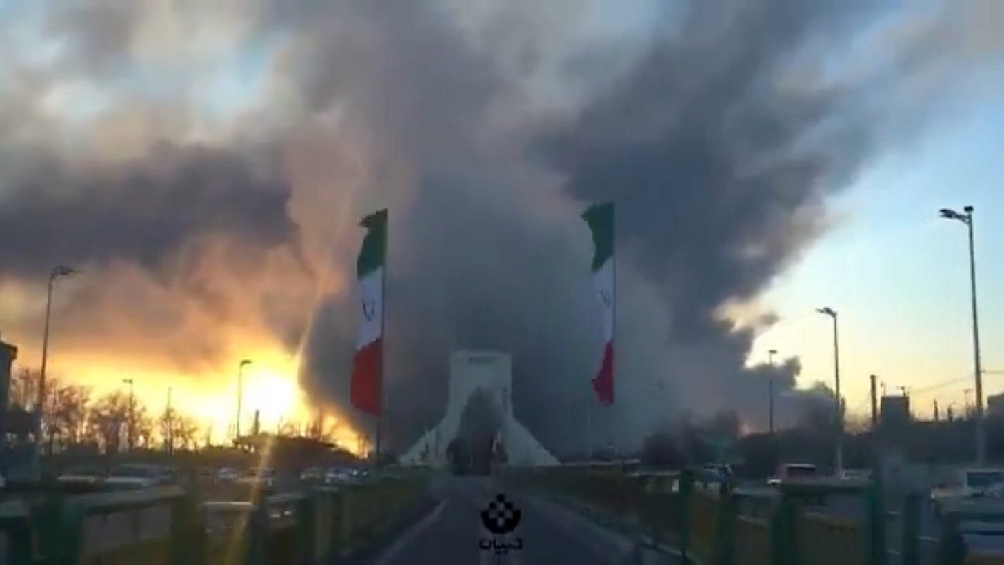 Smoke rises from bombings over Iranian flags Smoke rises from bombings over Iranian flags