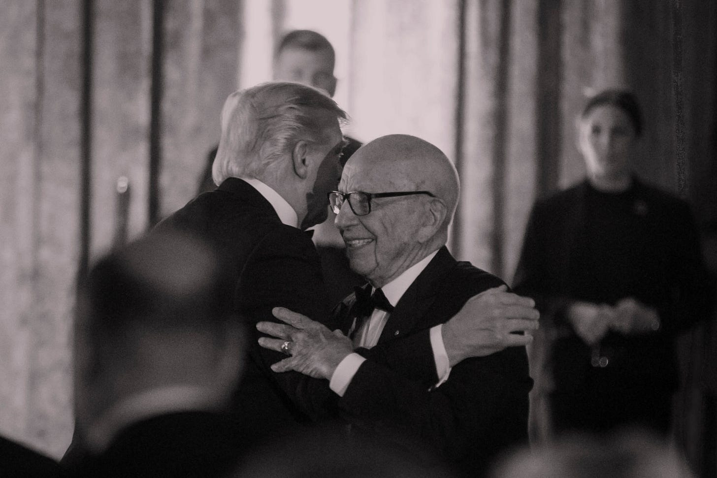 President Trump hugging Rupert Murdoch, both wearing tuxedos