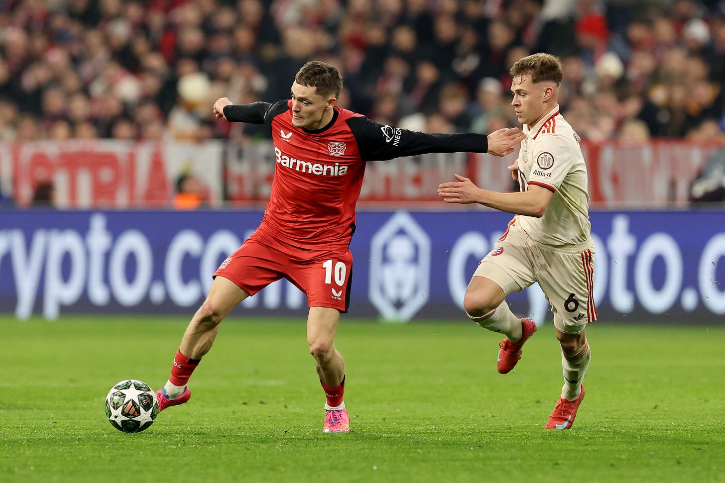 Florian Wirtz dribbles with the ball and holds off Bayern midfielder Joshua Kimmich. Florian Wirtz dribbles with the ball and holds off Bayern midfielder Joshua Kimmich.