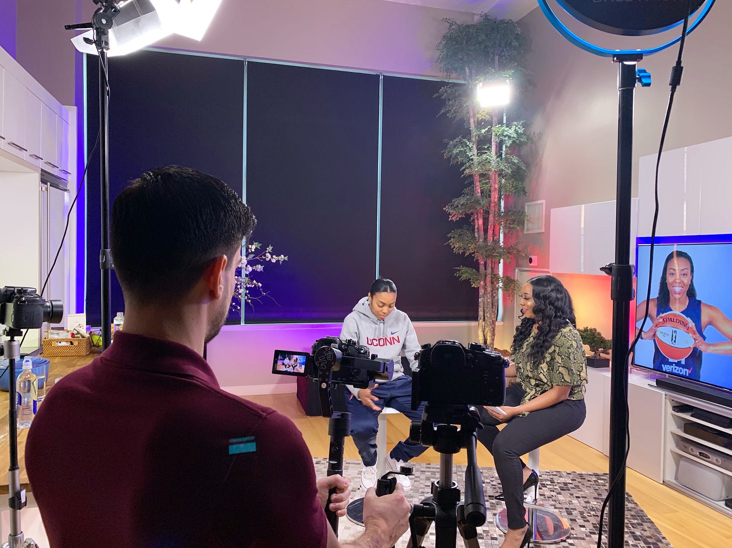 Khristina Williams interviews a UConn player on set during a Girls Talk Sports TV production Khristina Williams interviews a UConn player on set during a Girls Talk Sports TV production