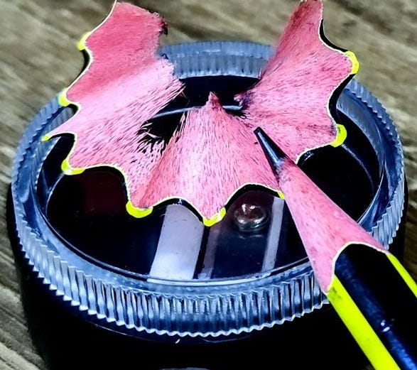 A pink and black object sitting on top of a wooden table