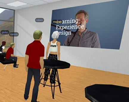 Screenshot of MootUp application, zoomed in to where avatars are watching a video playing on a wall.