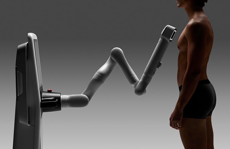 robot inspects skin of a male patient.