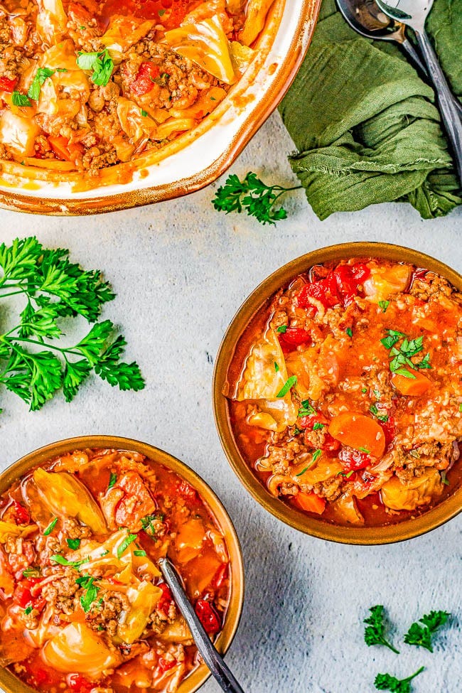 Slow Cooker Cabbage Roll Soup - A hearty comfort food soup recipe the whole family will love. If you think that soup can't be a meal, guess again! This slow cooker soup is chock full of bacon, ground beef, green cabbage, rice, carrots, fire roasted tomatoes, and more! Perfect for chilly weather, busy weeknights, and the leftovers freeze great! 