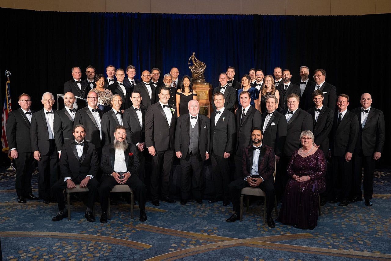 A group of people posing for a photo

Description automatically generated