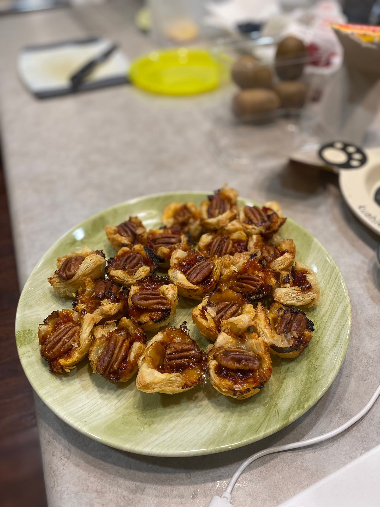 A green patterned plate of the tarts described above.