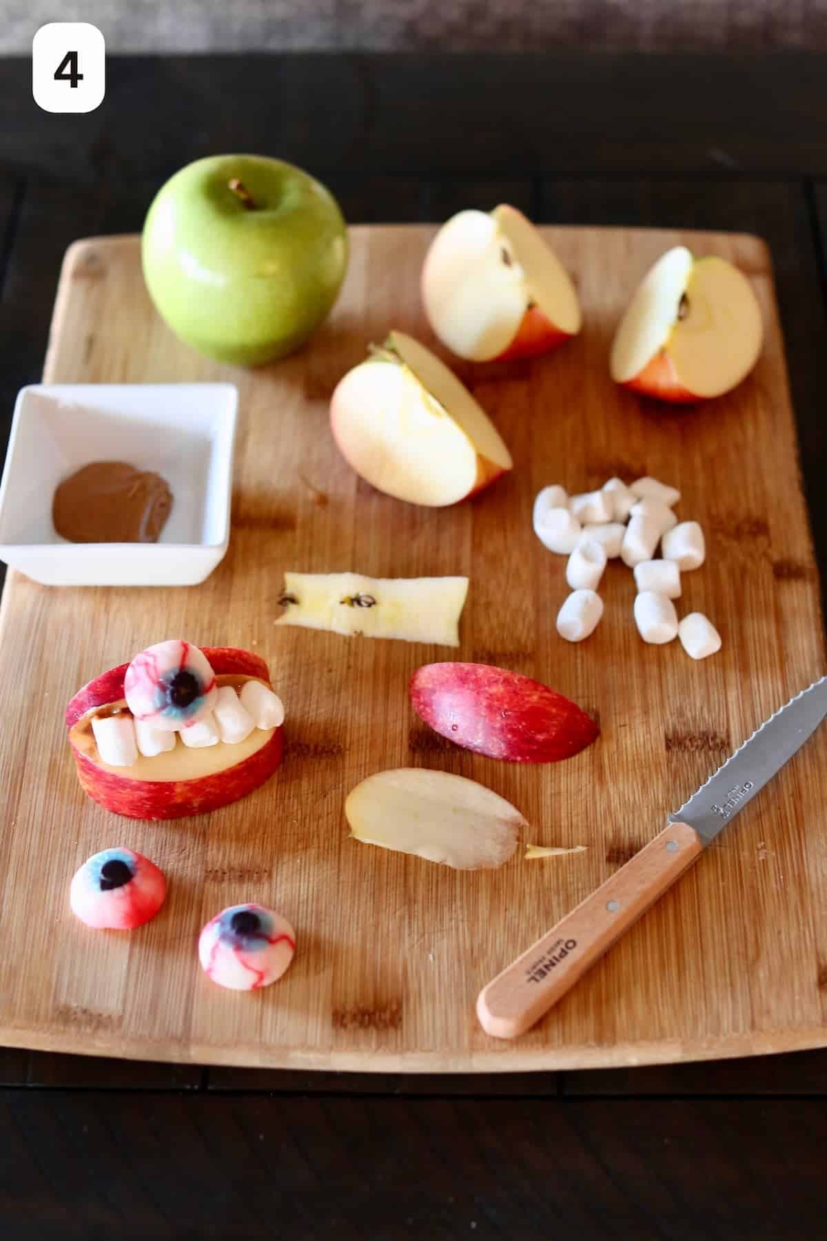 apples cut and decorated to look like false teeth.