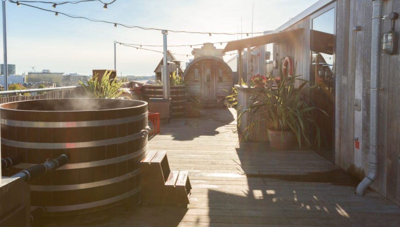 circular wooden hot tub on the roof of the hotel