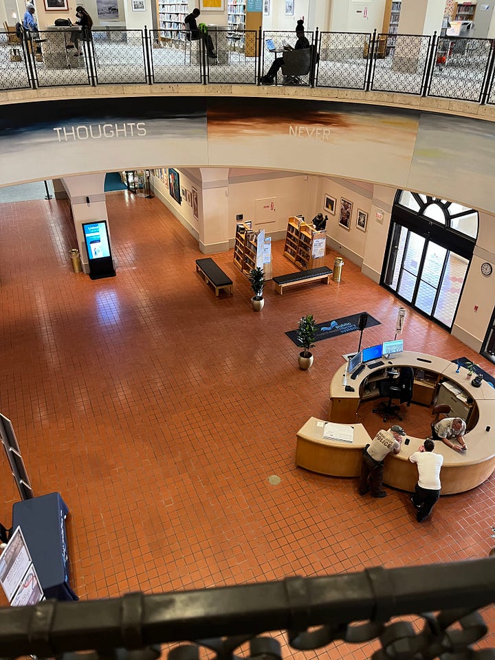 top left: exterior of Miami Pubic Library with Spanish tile courtyard; top right: view from second floor mezzanine looking down at the lobby of the Miami Public Library with orange tile floors and a central information desk; bottom left: books on the library shelf by Micol Ostow; bottom right: some art and special collections on the second floor