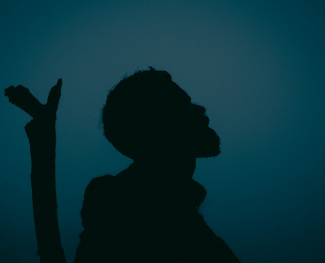 Silhouette of a man with beard against blue background Silhouette of a man with beard against blue background