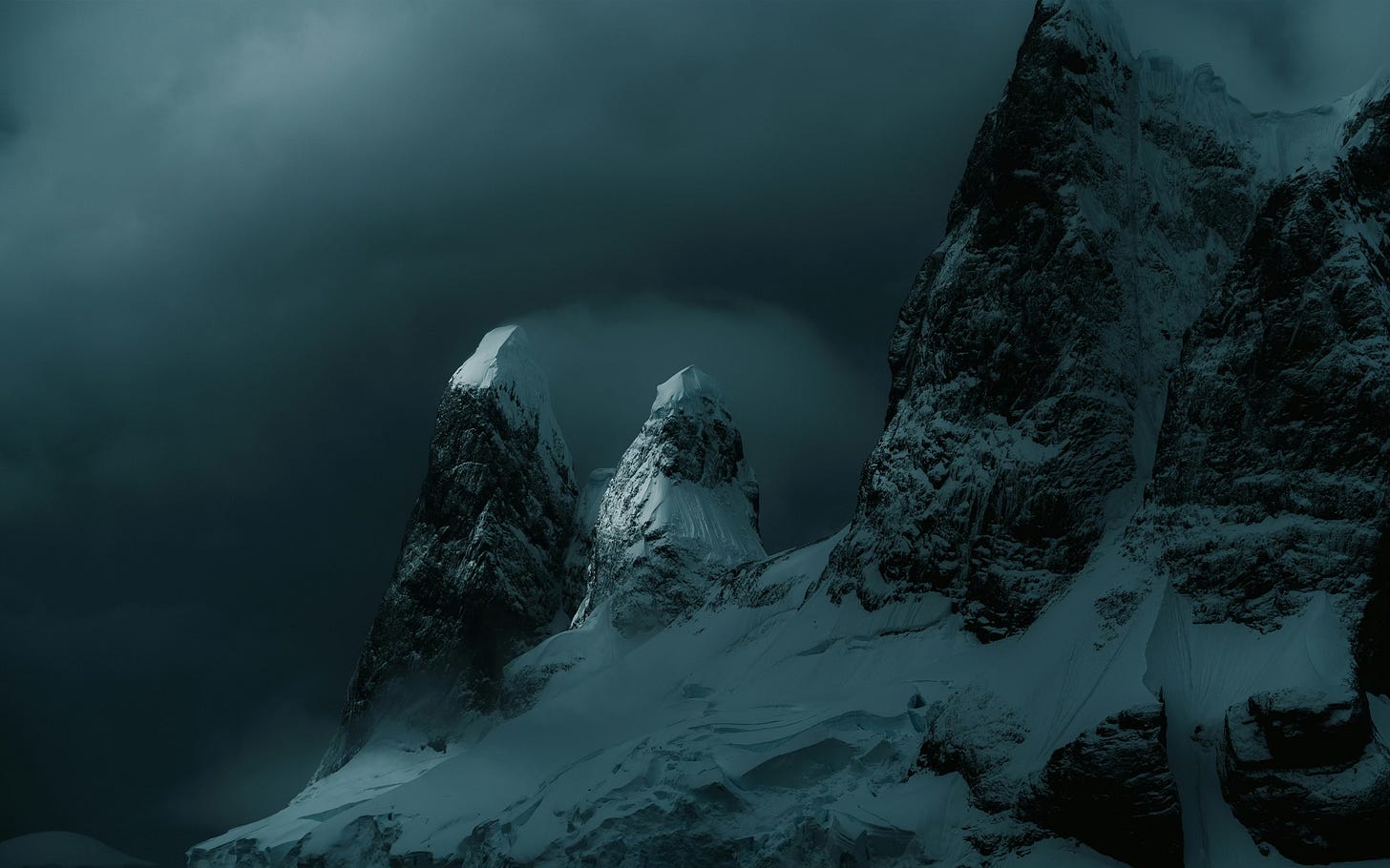 Photograph shows mountain peaks covered in snow with a stormy background Photograph shows mountain peaks covered in snow with a stormy background