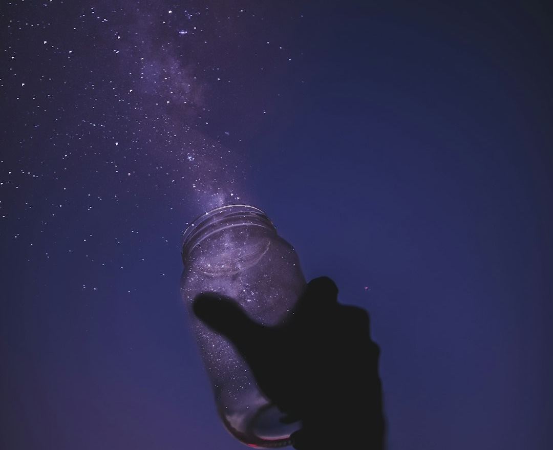 person holding glass jar