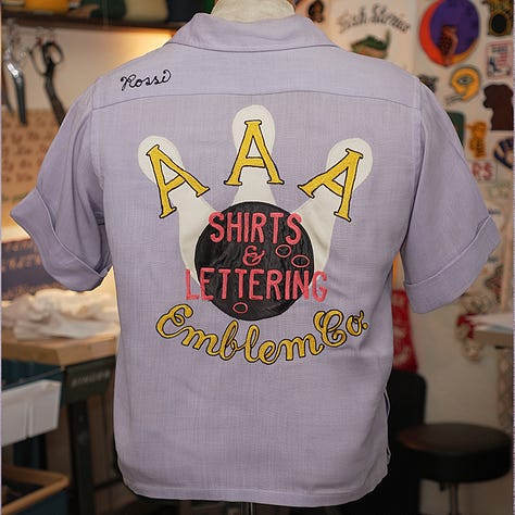 Purple bowling shirt with black embroidery showing "Mary" and "Rossi