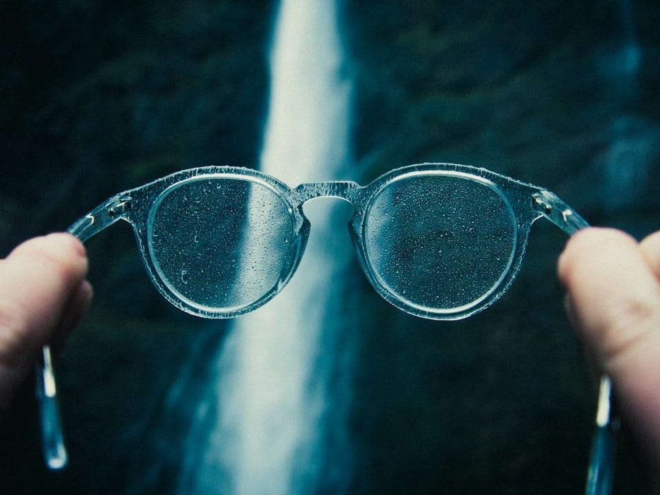 person holding eyeglasses