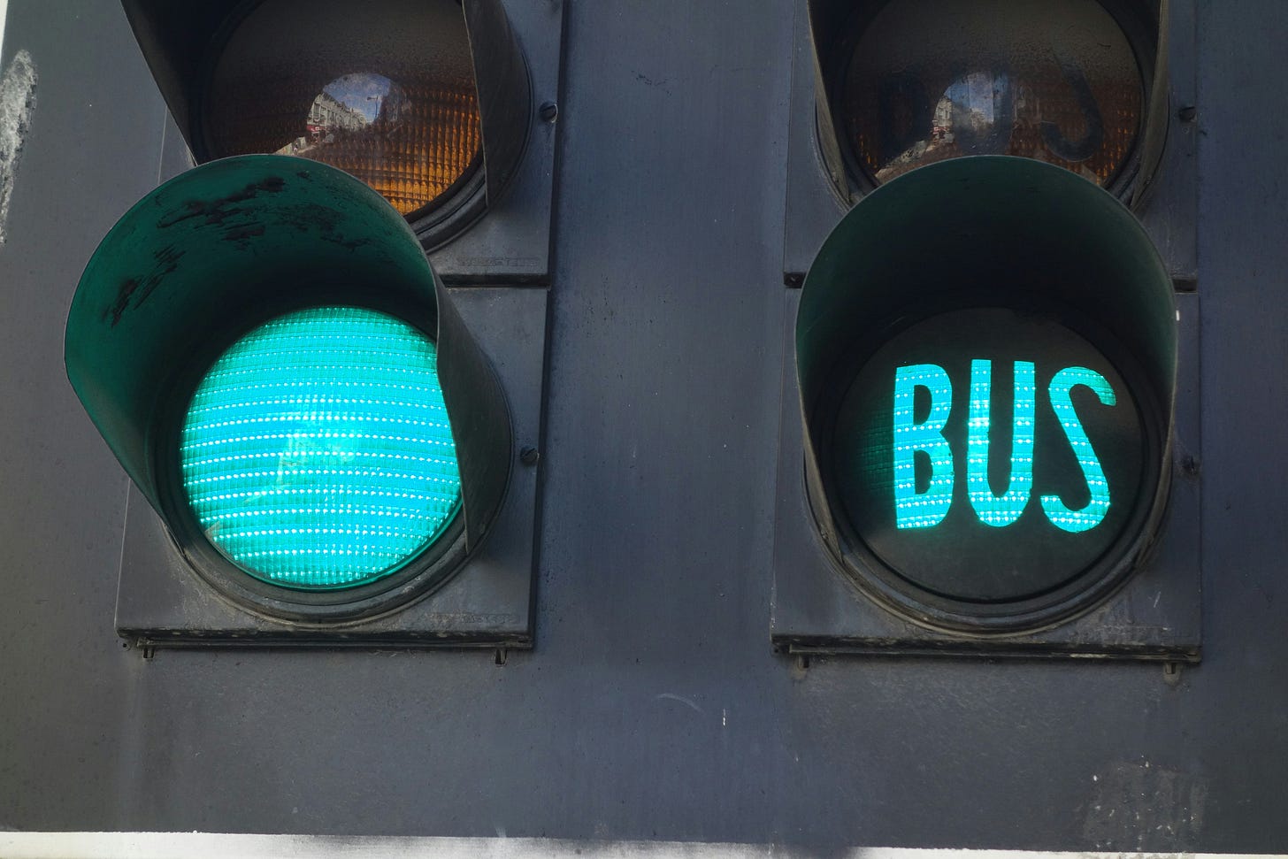 An image of green traffic lights, one of which spells out the word Bus An image of green traffic lights, one of which spells out the word Bus