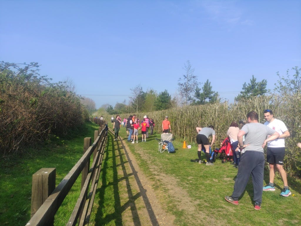 The finishing line, with a bush marking one side and wooden railings the other. The finishing line, with a bush marking one side and wooden railings the other.