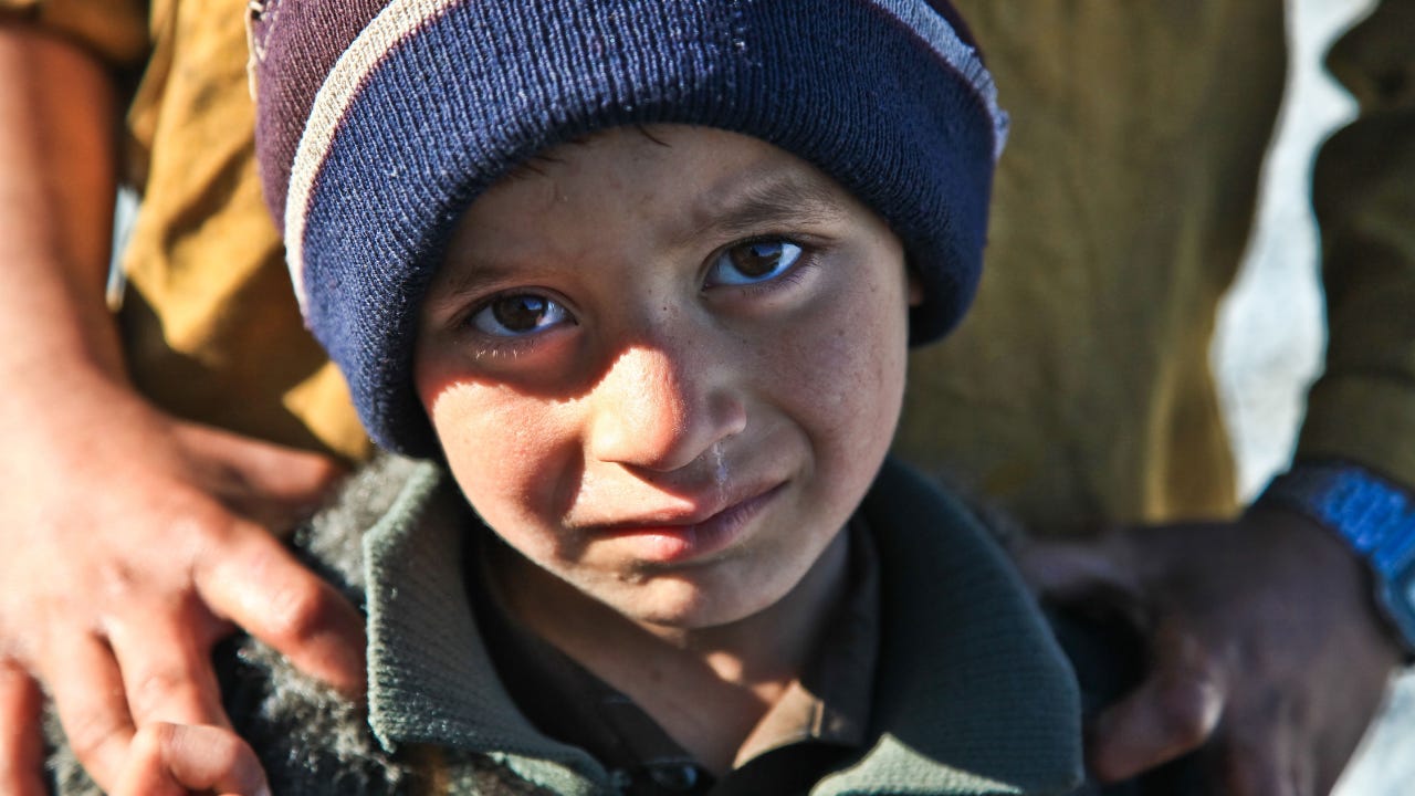 A child in war time looking sad. A child in war time looking sad.