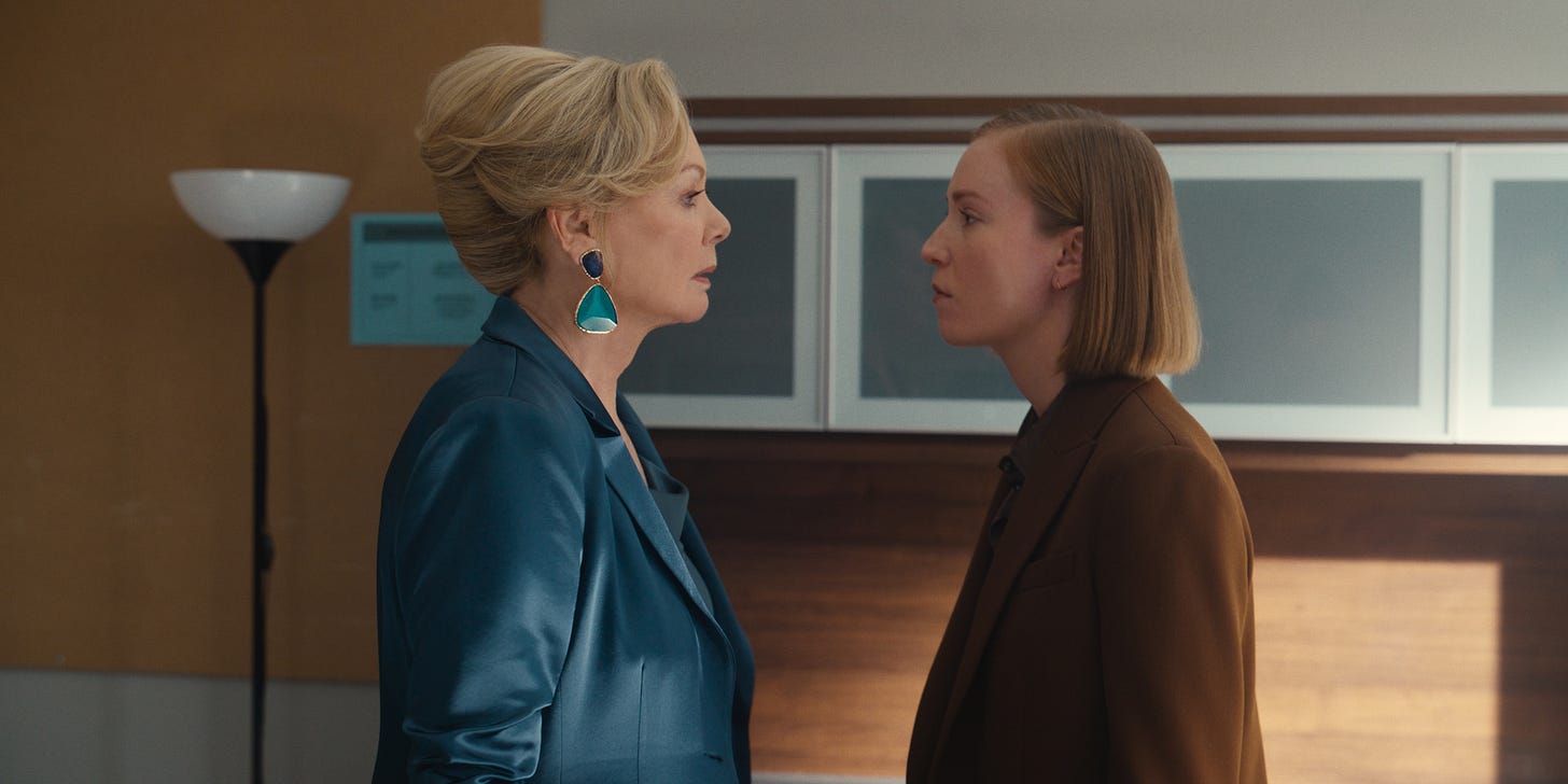 A still from the Season 3 finale of Hacks. Ava (Hannah Einbinder) and Deborah (Jean Smart), each wearing power blazers, stand facing each other and glowering. A still from the Season 3 finale of Hacks. Ava (Hannah Einbinder) and Deborah (Jean Smart), each wearing power blazers, stand facing each other and glowering.
