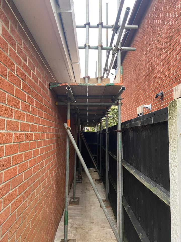 scaffolding constructed at the front and back of the house