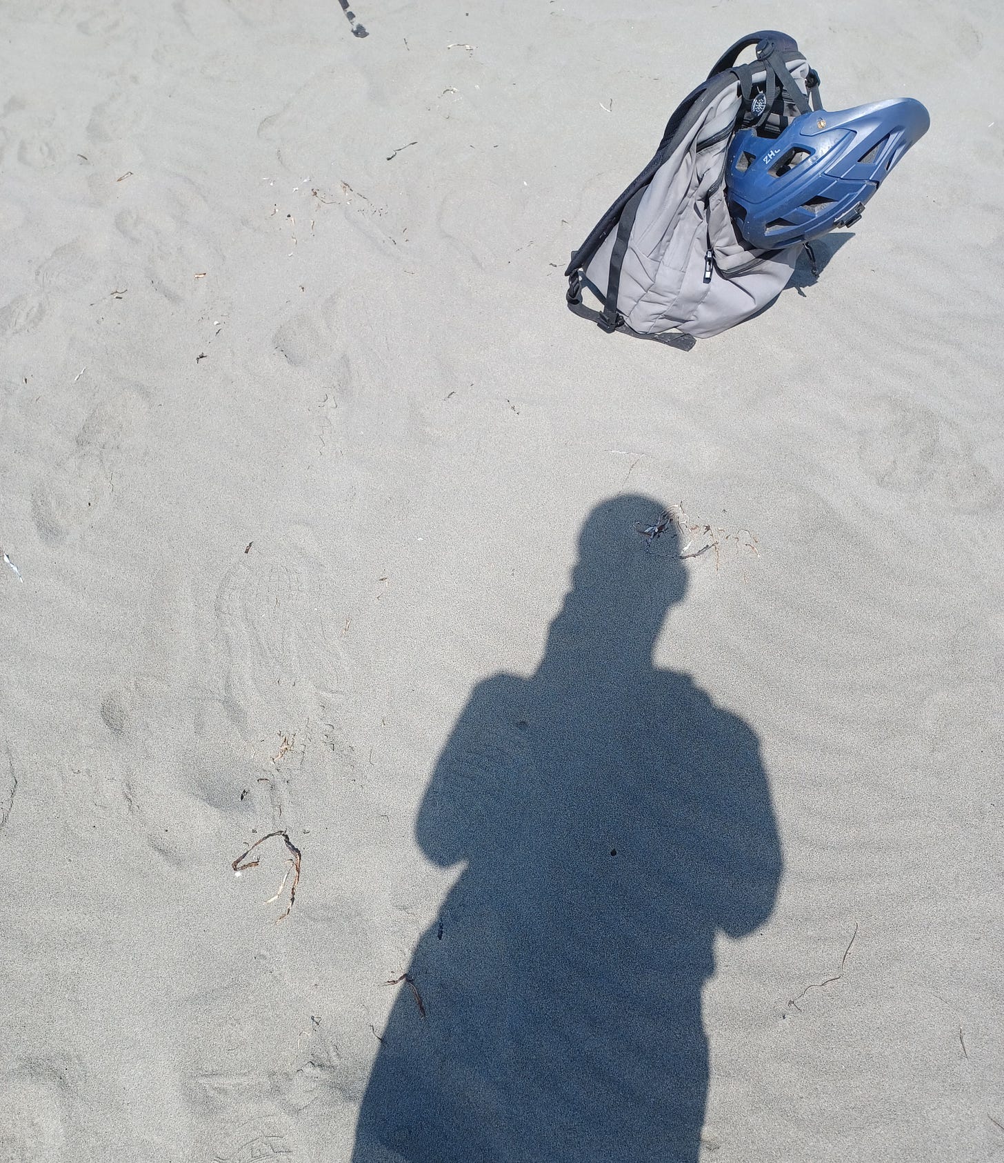 The author in silhouette taking a smartphone picture on a California beach, August 21, 2025.