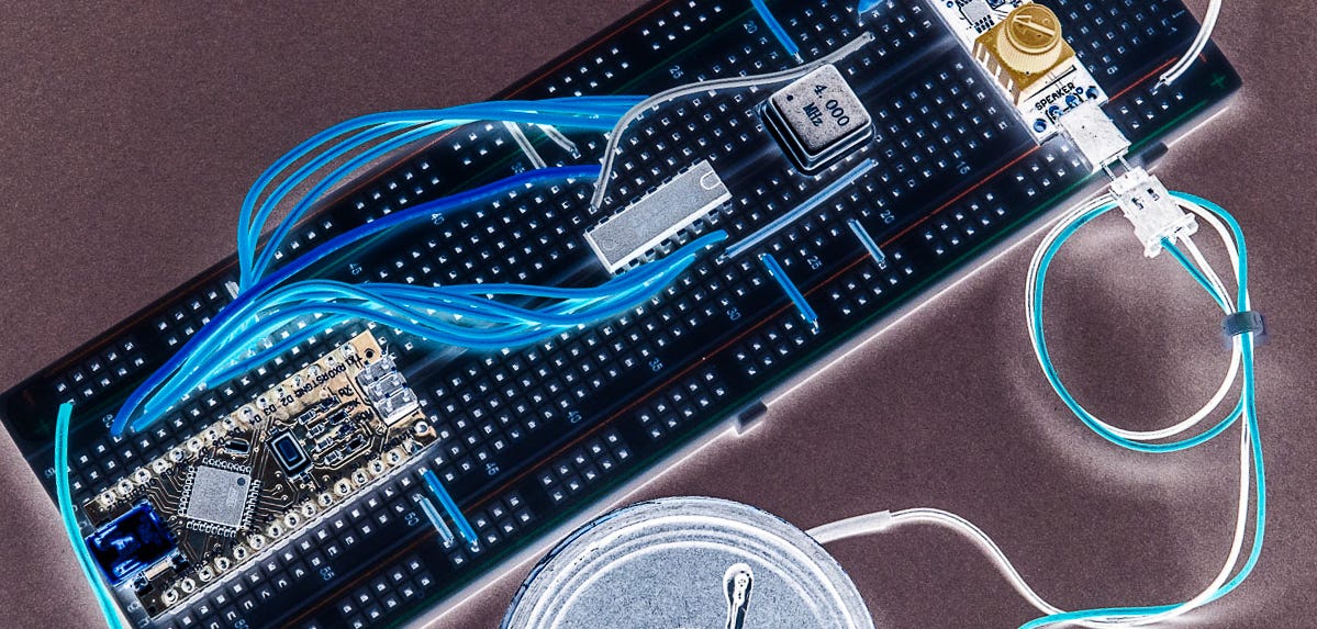 Manipulated image of an electronics prototyping breadboard with a microcontroller, chip, oscillator, amplifier and speaker