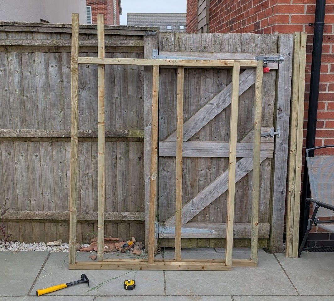 Two completed wooden shed side frames, ready for cladding