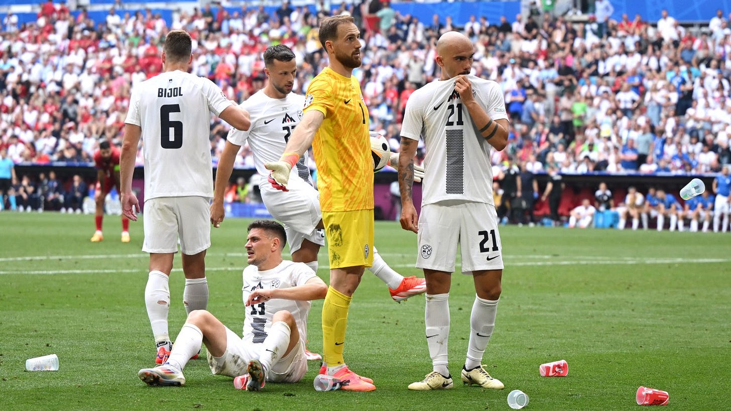 Slovenian players getting pelted with cups Slovenian players getting pelted with cups