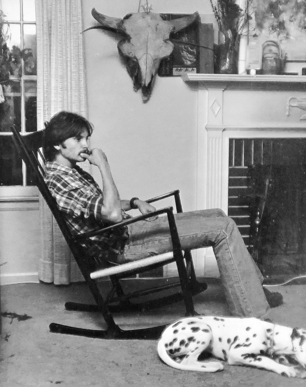 A person sitting in a rocking chair

Description automatically generated