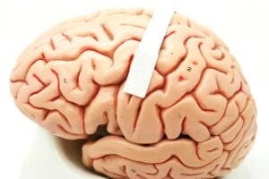 A device no bigger than a postage stamp (dotted portion within white band) packs 128 microscopic sensors that can translate brain cell activity into what someone intends to say.