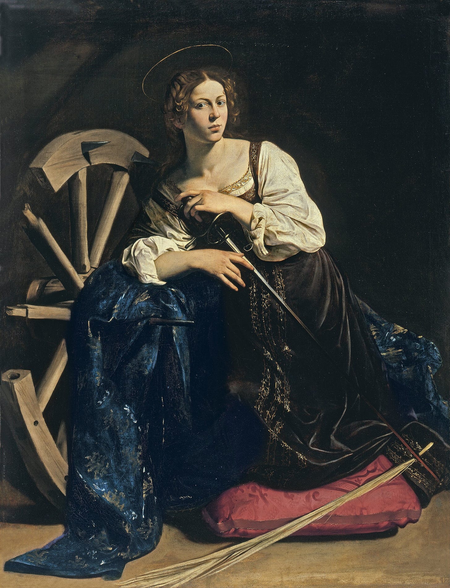 A kneeling woman in a red robe leaning on a broken wheel with iron spikes, a sword at her side
