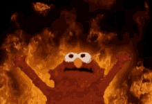 Elmo in front of fire