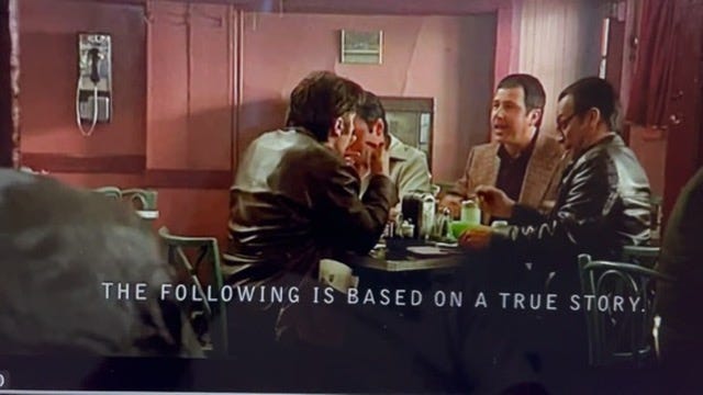 A group of men sitting at a table

Description automatically generated