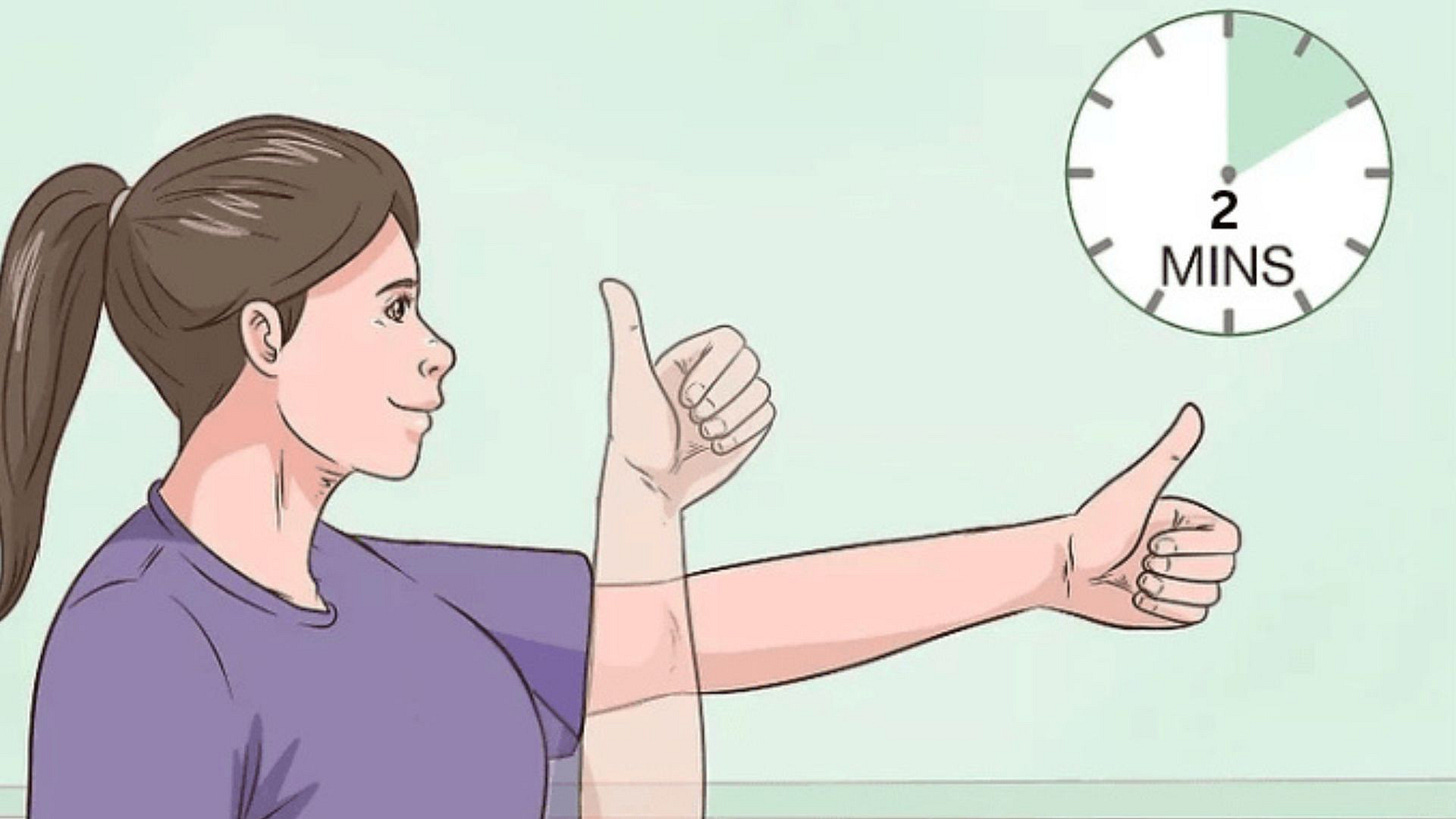 Person demonstrating focus change exercise by holding thumb at arm's length while alternating focus between thumb and distant object