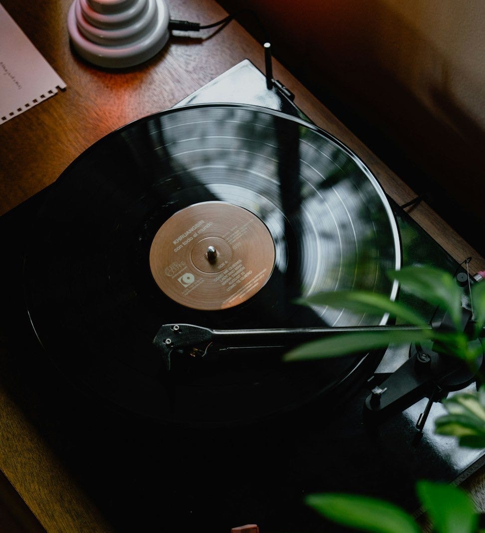 black turntable on brown wooden table