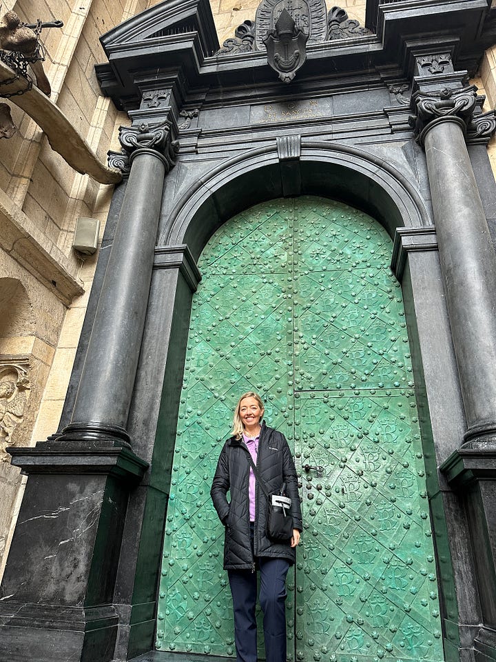Author in front of historical buildings and doors