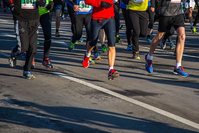 runners jogging along a road