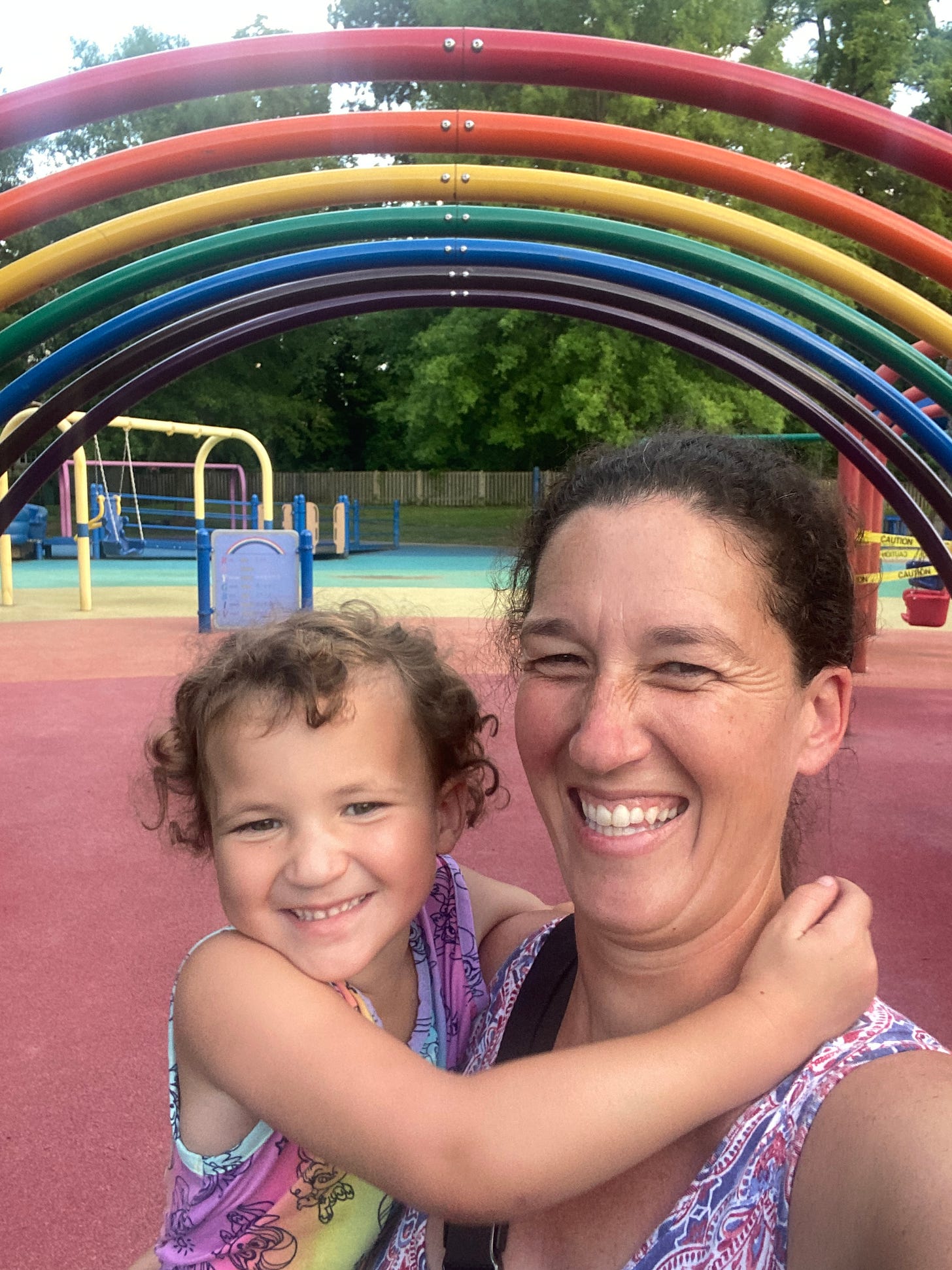 Lydia and Addy in front of the rainbow at Clemyjontri Park in McLean, VA Lydia and Addy in front of the rainbow at Clemyjontri Park in McLean, VA